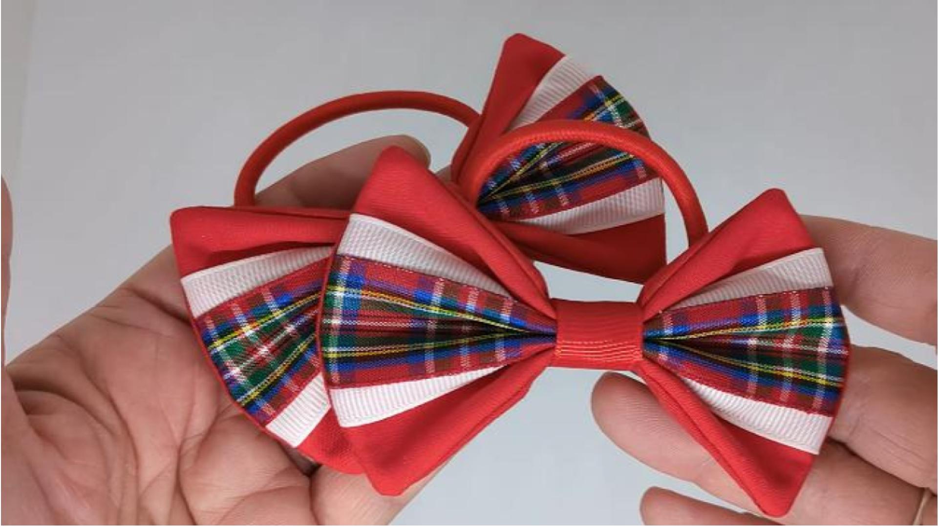 Close-up of red Royal Stewart tartan hair bows on thick bobbles, measuring 9cm x 6cm, showcasing the traditional tartan pattern and cotton fabric.