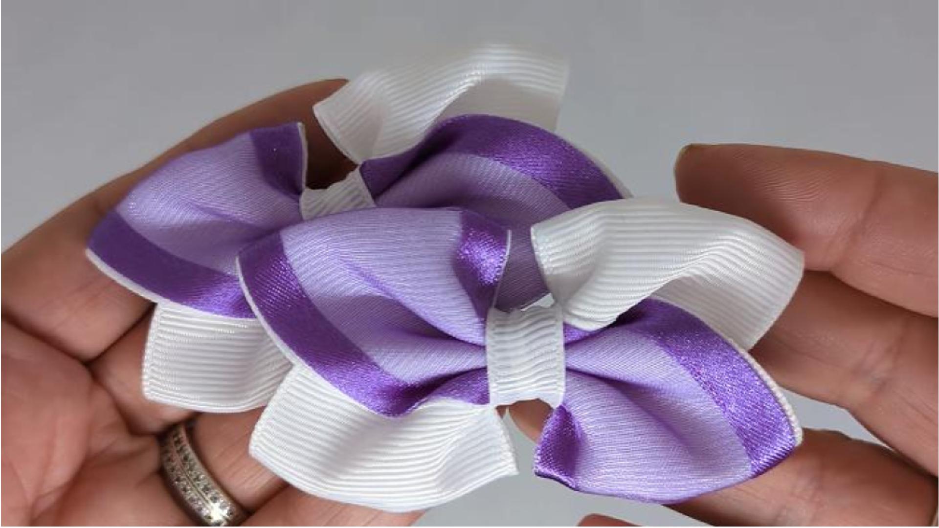 Close-up of white and purple organza hair bows on alligator clips, measuring 7cm x 5cm, showcasing the delicate combination of organza and grosgrain ribbon.