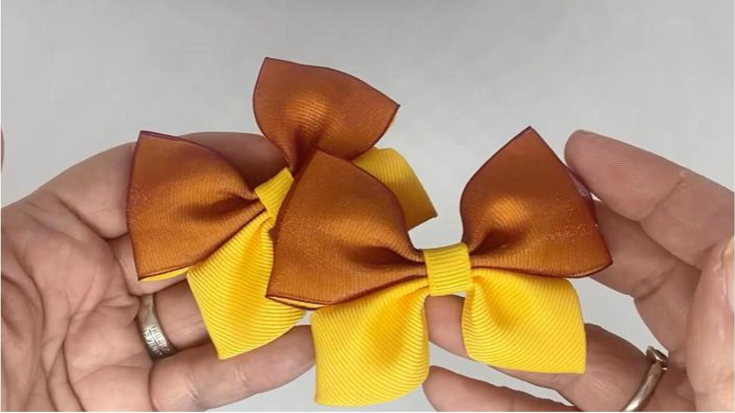 Close-up of golden yellow and burgundy organza hair bows on alligator clips, measuring 8cm x 6cm, showcasing the soft combination of grosgrain and organza ribbon.