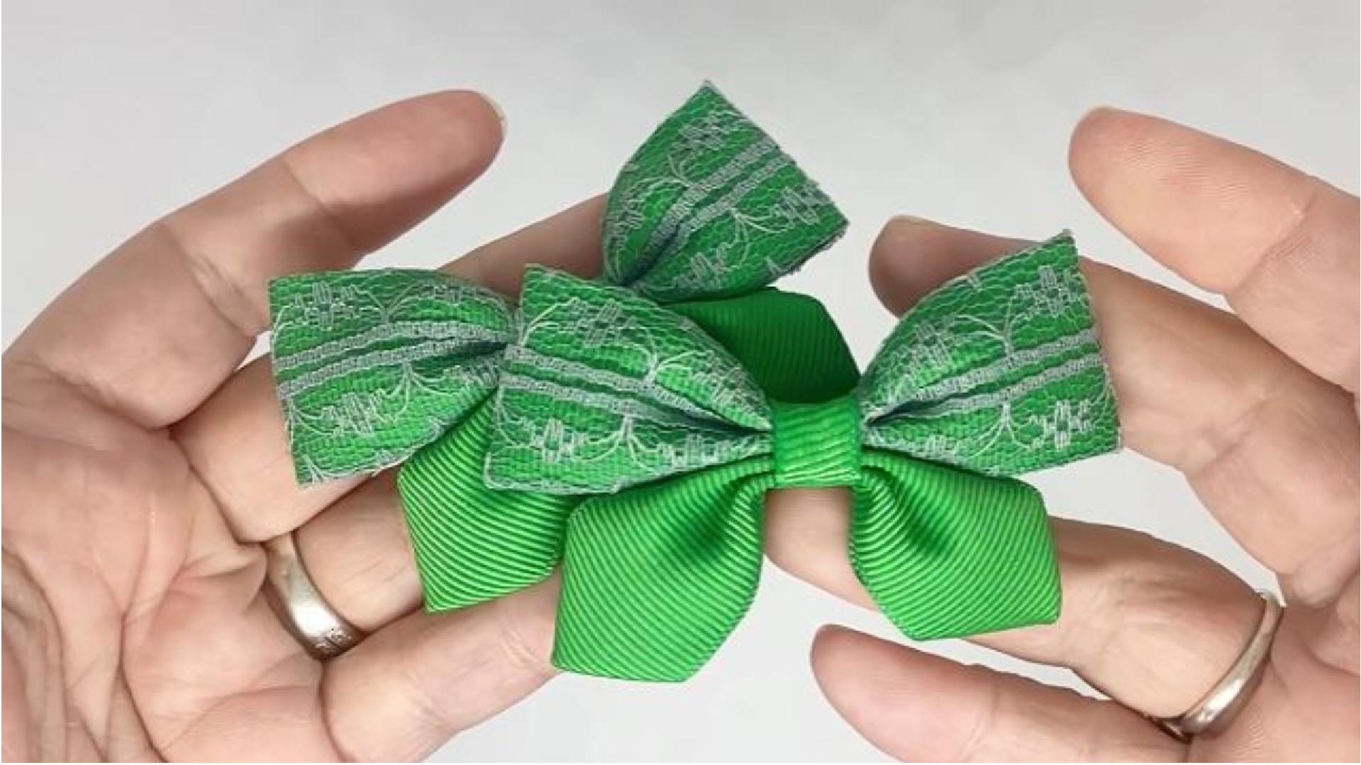 Close-up of emerald green and grey lace hair bows on alligator clips, measuring 7cm x 5cm, showcasing the elegant lace and grosgrain ribbon combination.