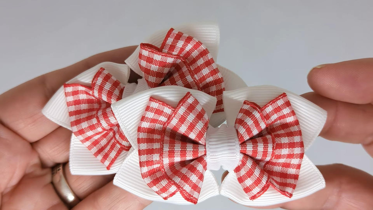 Close-up of white and red gingham hair bows on alligator clips, measuring 7cm x 5cm, showcasing the gingham pattern and grosgrain ribbon detail.