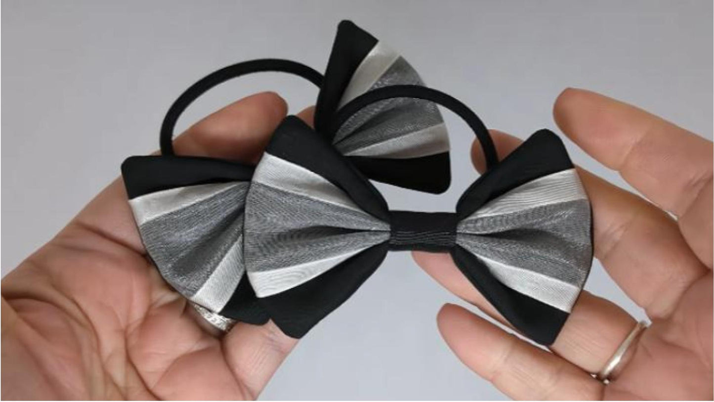 Close-up of black and white organza hair bows on thick bobbles, measuring 9cm x 6cm, showcasing the soft organza and cotton fabric combination.