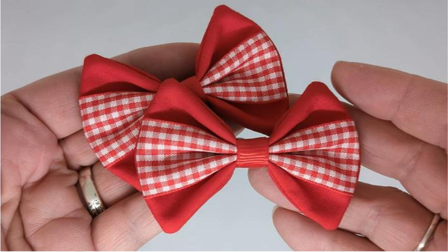 Close-up of red gingham hair bows on alligator clips, measuring 7cm x 5cm, showcasing the classic gingham pattern and cotton fabric.