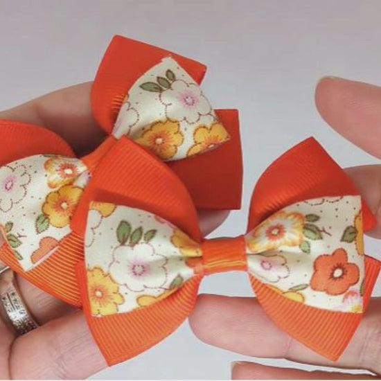 Orange floral hair bows on alligator clips